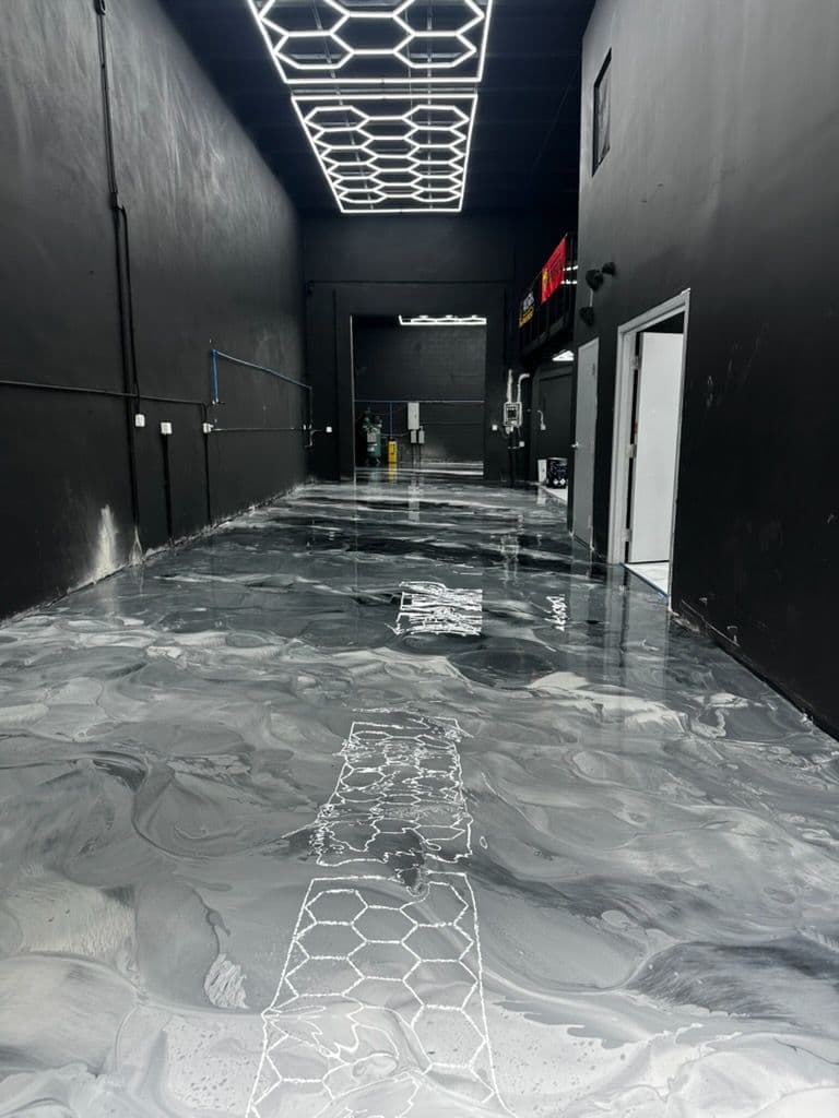 Sleek Metallic Epoxy Floor for Nizo Motorsports